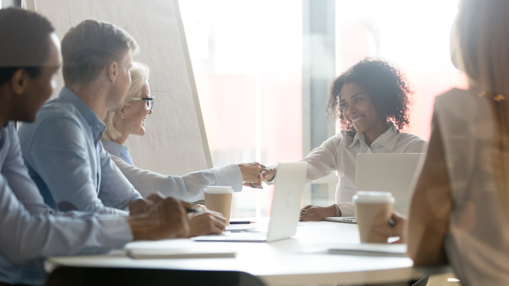 Female leader handshake partner client making commercial deal agreement