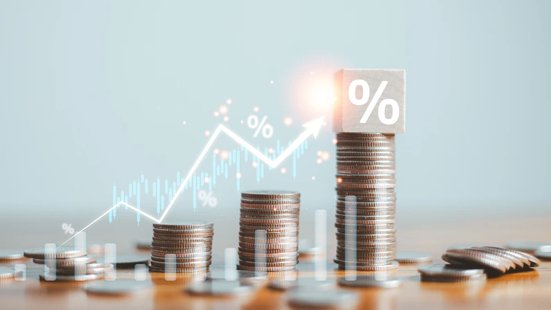 Stacks of coins with trend line and percentage symbols, symbolizing growth in business development strategies.