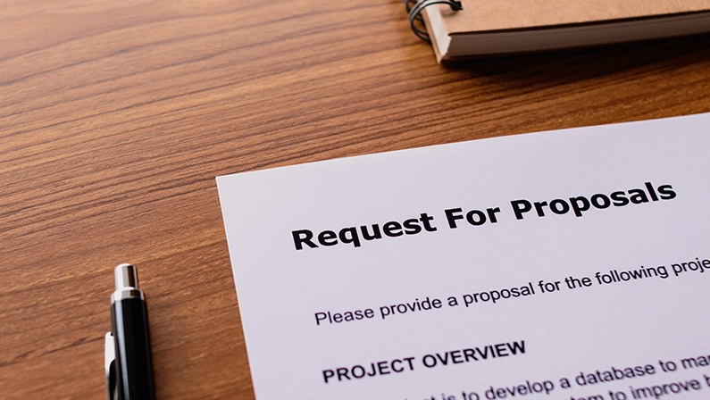 Close-up of a request for proposals (RFP) document on a desk, representing the RFP process in business procurement.