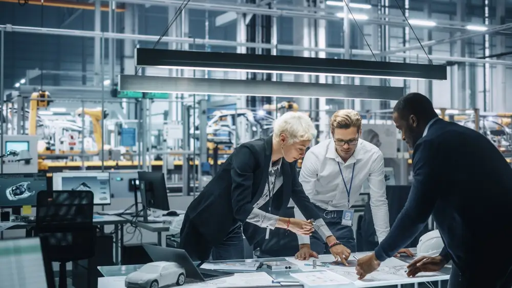 Engineers collaborating on innovation projects in a high-tech lab, representing research and development funded by SBIR Grants.