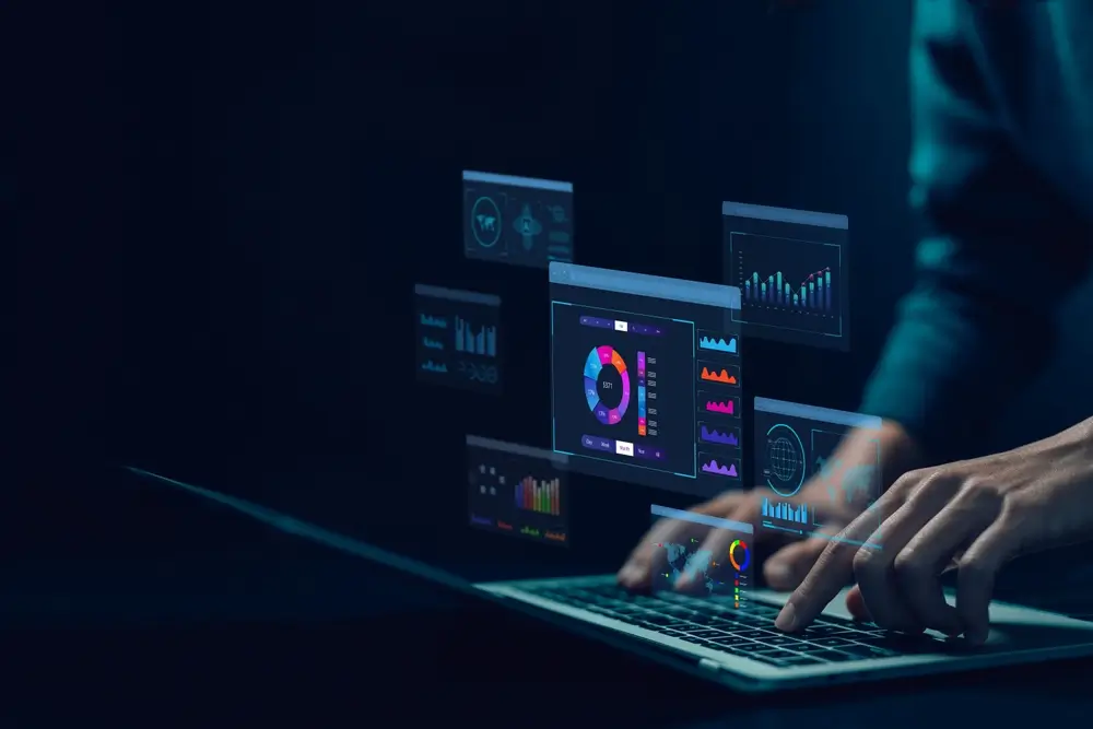 Hands typing on a laptop with floating data analytics, representing digital insights and winning market strategies.