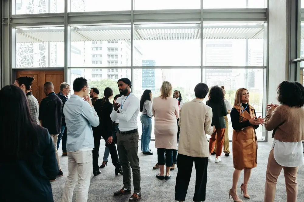 Corporate crowd showcasing teamwork and networking during a business event in a contemporary office setting