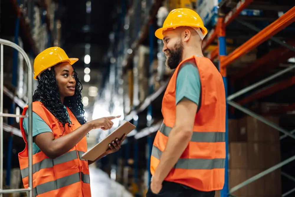 warehouse employees strategize logistics in a lively discussion