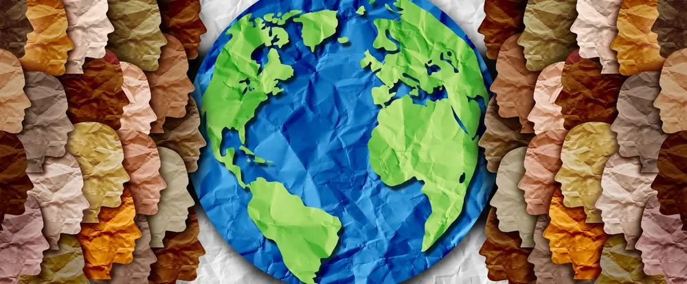 A diverse global community represented by colorful paper-cut faces surrounding the Earth, symbolizing unity in international relations.