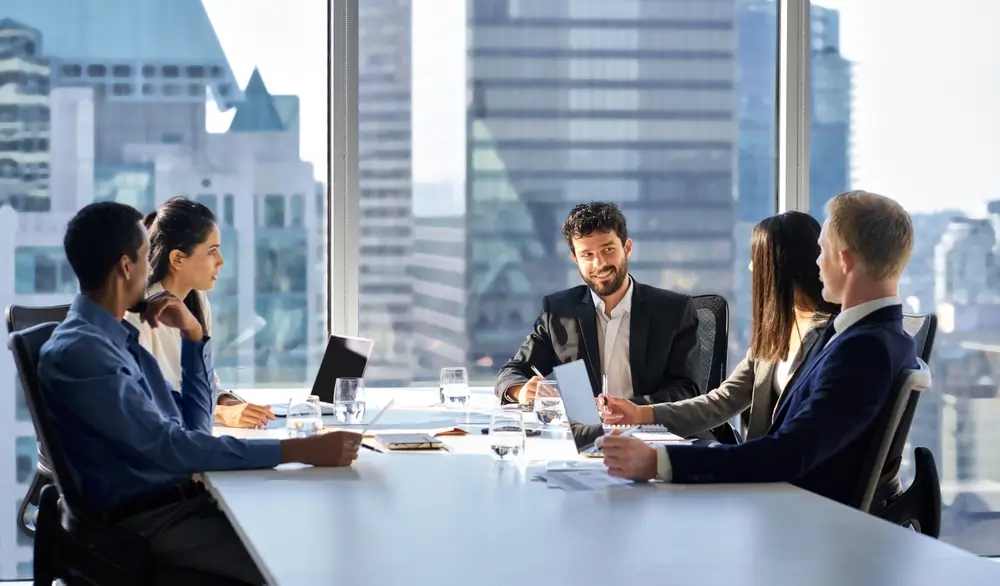 A diverse group of executives in a corporate meeting, strategizing international relations and global business expansion.