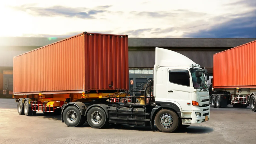 Semi Trailer Trucks on The Parking Lot in Warehouse. Truck Loading Goods at Warehouse. Container Shipping. Tractor Truck. Trucking. Lorry Diesel Trucks. Freight Truck Logistics Cargo Transport.