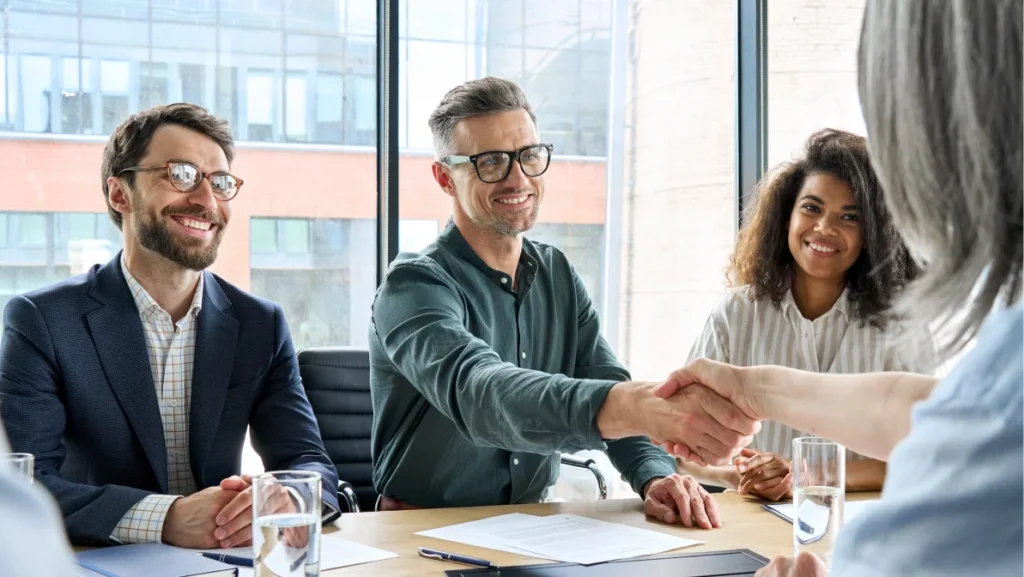 Business leaders finalize a partnership built on shared job creation strategies and economic growth goals.