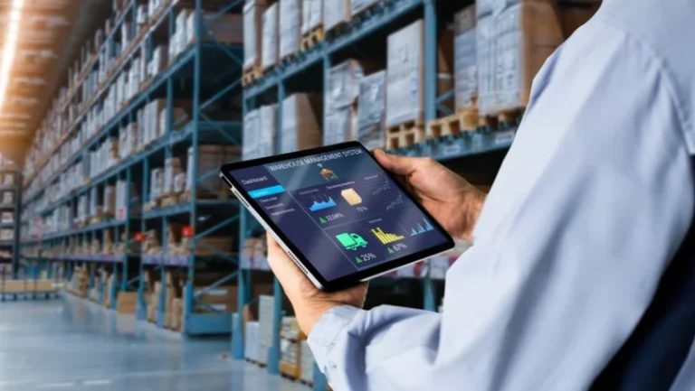 Smart Warehouse,Inventory management system concept.Manager using digital tablet,showing warehouse software management dashboard on blurred warehouse as background